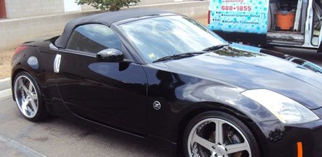 Black 350Z roadster beside the Lee's mobile unit
