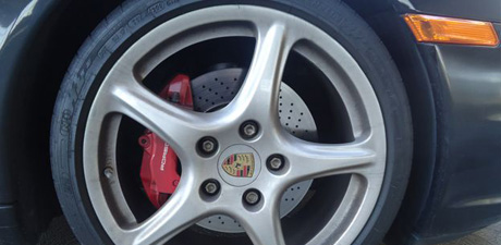 Porsche wheel with red brake calipers after a wheel detail