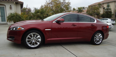Maroon Jaguar XF with a deep glossy finish after an exterior detail
